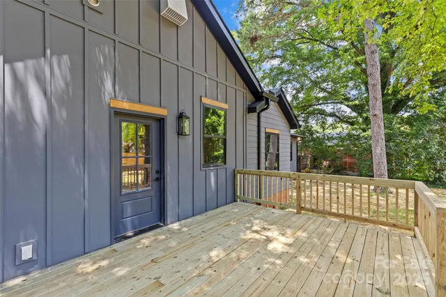 a view of balcony with wooden floor and fence