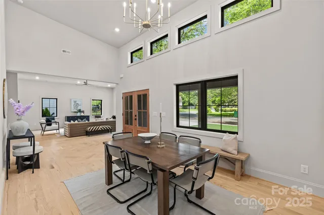 a living room with furniture a window and a potted plant