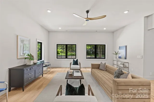 a living room with furniture and a large window