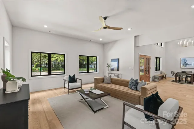 a living room with furniture and large windows