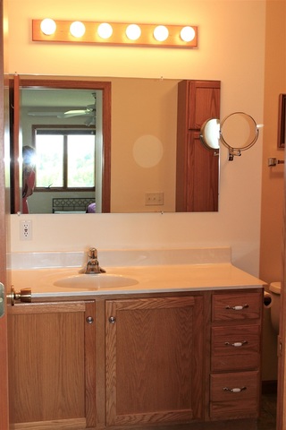15539 Henry Road, Unit A Morrison, IL 61270 - Photo 14 of 32 a bathroom with a sink and a mirror