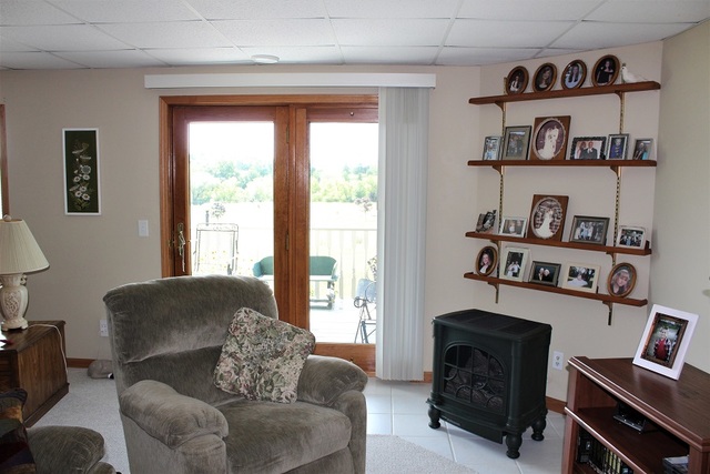 15539 Henry Road, Unit A Morrison, IL 61270 - Photo 22 of 32 a living room with furniture and a fireplace