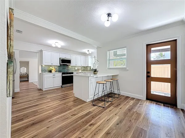 a view of a dining room with furniture window and wooden floor