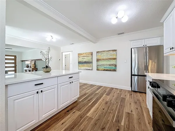 a view of a dining room with furniture and wooden floor