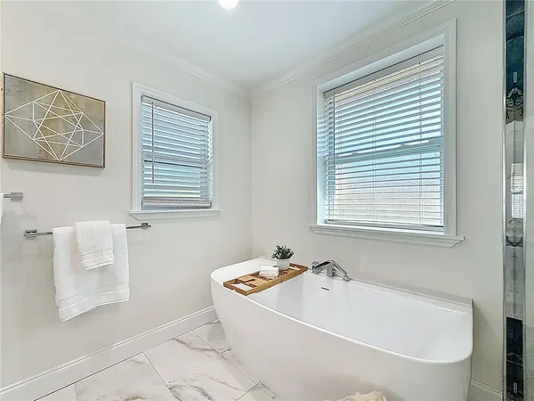 a bedroom with a bed and a ceiling fan