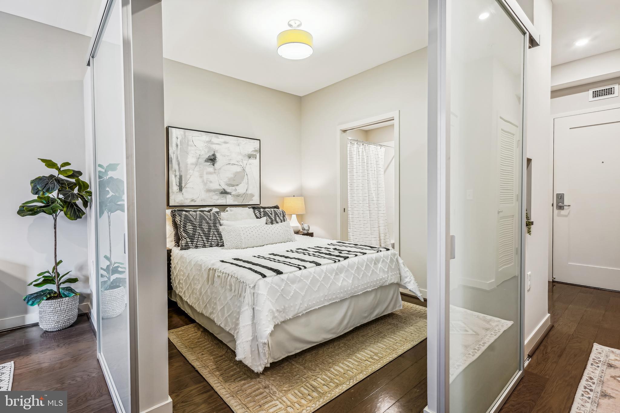 1320 Fenwick Lane, Unit 507 Silver Spring, MD 20910 - Photo 11 of 46 a bedroom with a bed and a potted plant