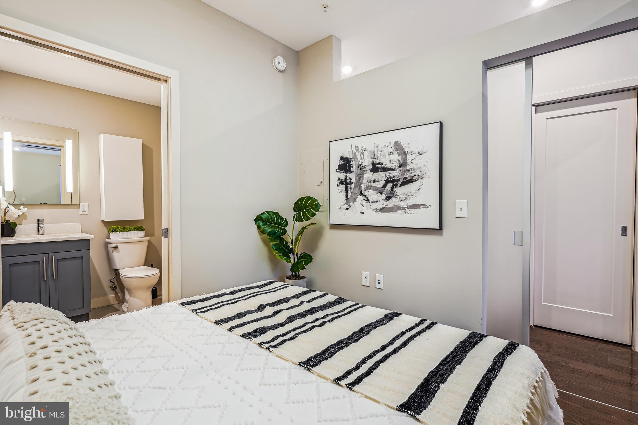 1320 Fenwick Lane, Unit 507 Silver Spring, MD 20910 - Photo 15 of 46 a bedroom with a bed and a chandelier