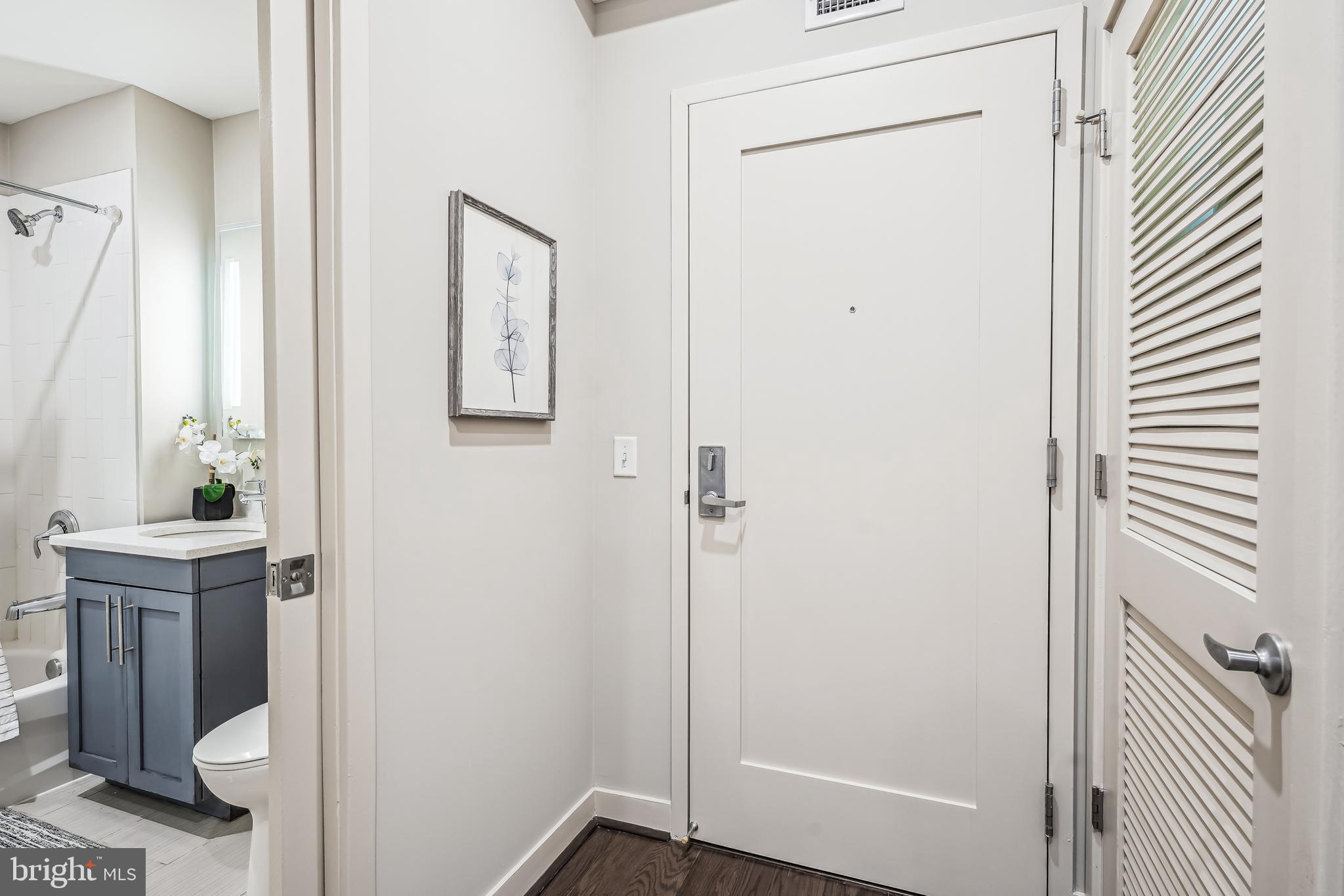 1320 Fenwick Lane, Unit 507 Silver Spring, MD 20910 - Photo 3 of 46 a view of a bathroom from a hallway