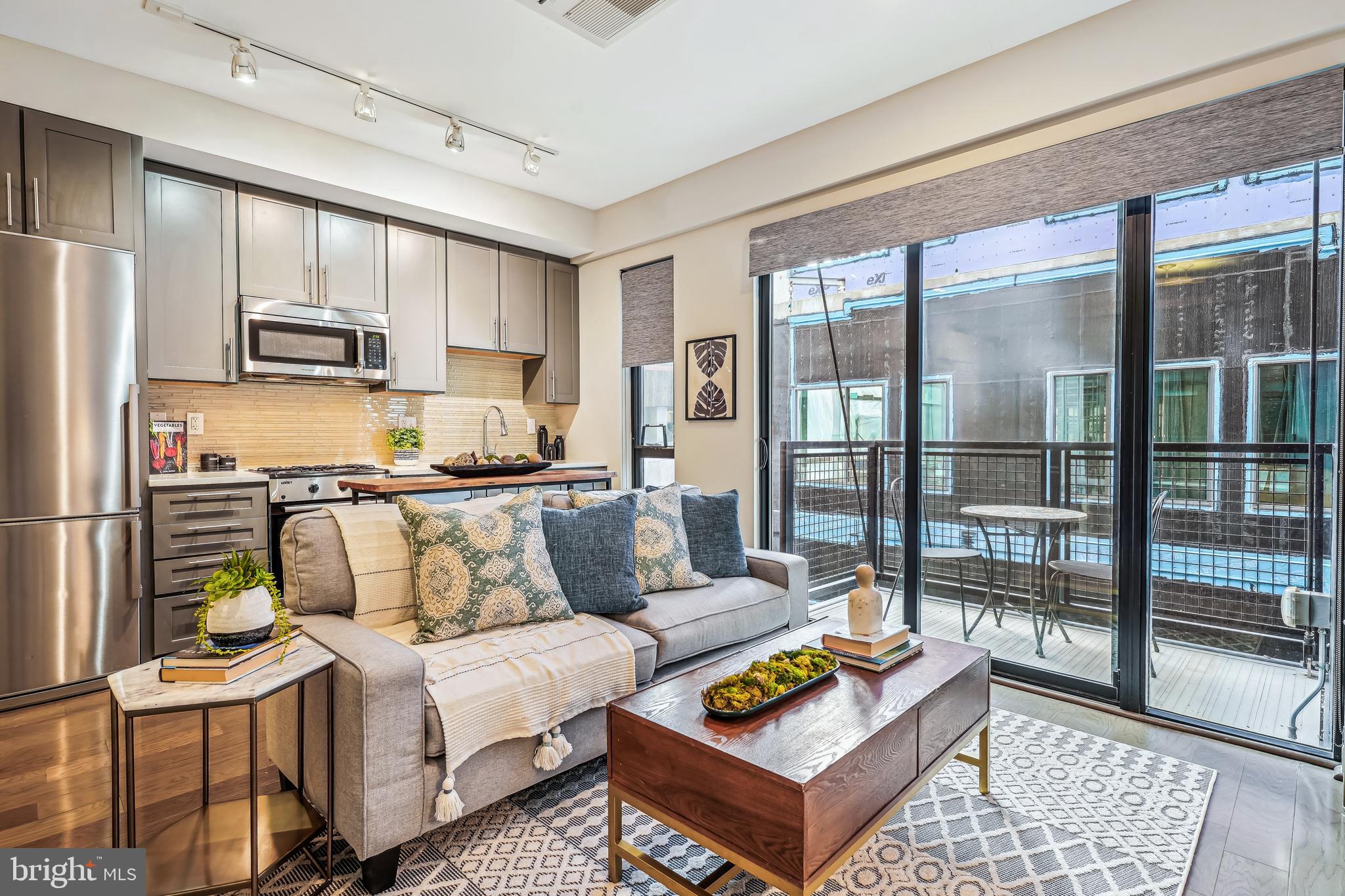1320 Fenwick Lane, Unit 507 Silver Spring, MD 20910 - Photo 6 of 46 a living room with furniture and a rug