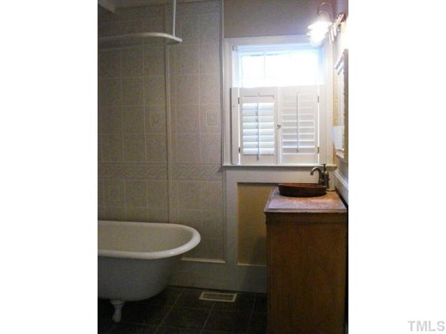 3038 Lewis Farm Road Raleigh, NC 27607 - Photo 11 of 12 a bathroom with a toilet a sink and mirror