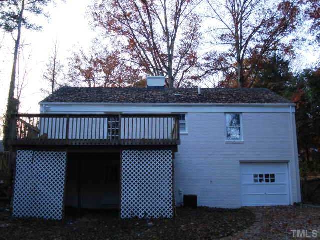 3038 Lewis Farm Road Raleigh, NC 27607 - Photo 12 of 12 a view of a brick house with large space and large trees