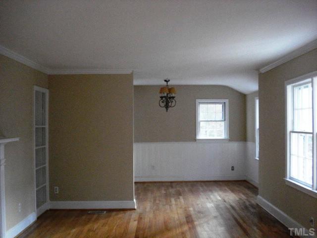 3038 Lewis Farm Road Raleigh, NC 27607 - Photo 3 of 12 an empty room with wooden floor and windows