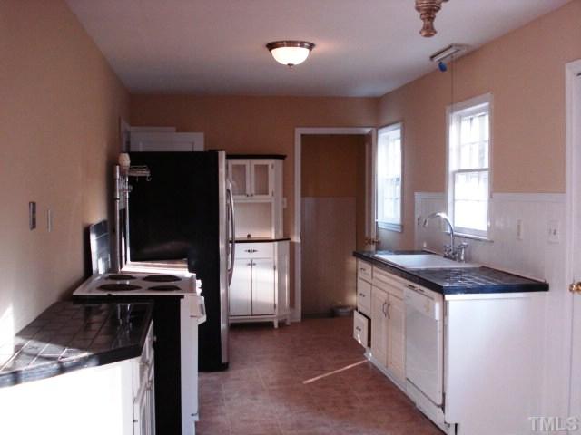 3038 Lewis Farm Road Raleigh, NC 27607 - Photo 6 of 12 a kitchen with a stove and a refrigerator