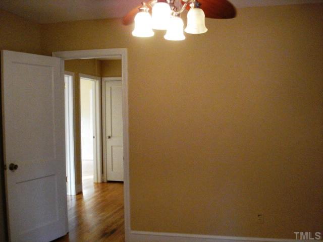 3038 Lewis Farm Road Raleigh, NC 27607 - Photo 8 of 12 a view of a hallway with wooden floor