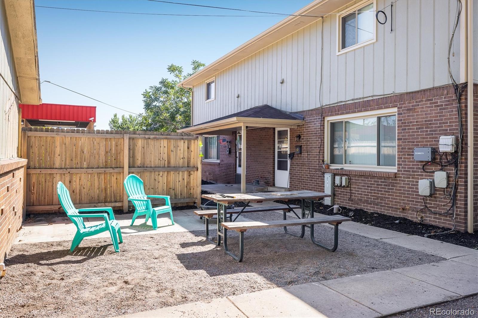 3830 Otis Street, Unit 14 Wheat Ridge, CO 80033 - Photo 18 of 26 a backyard of a house with barbeque oven table and chairs