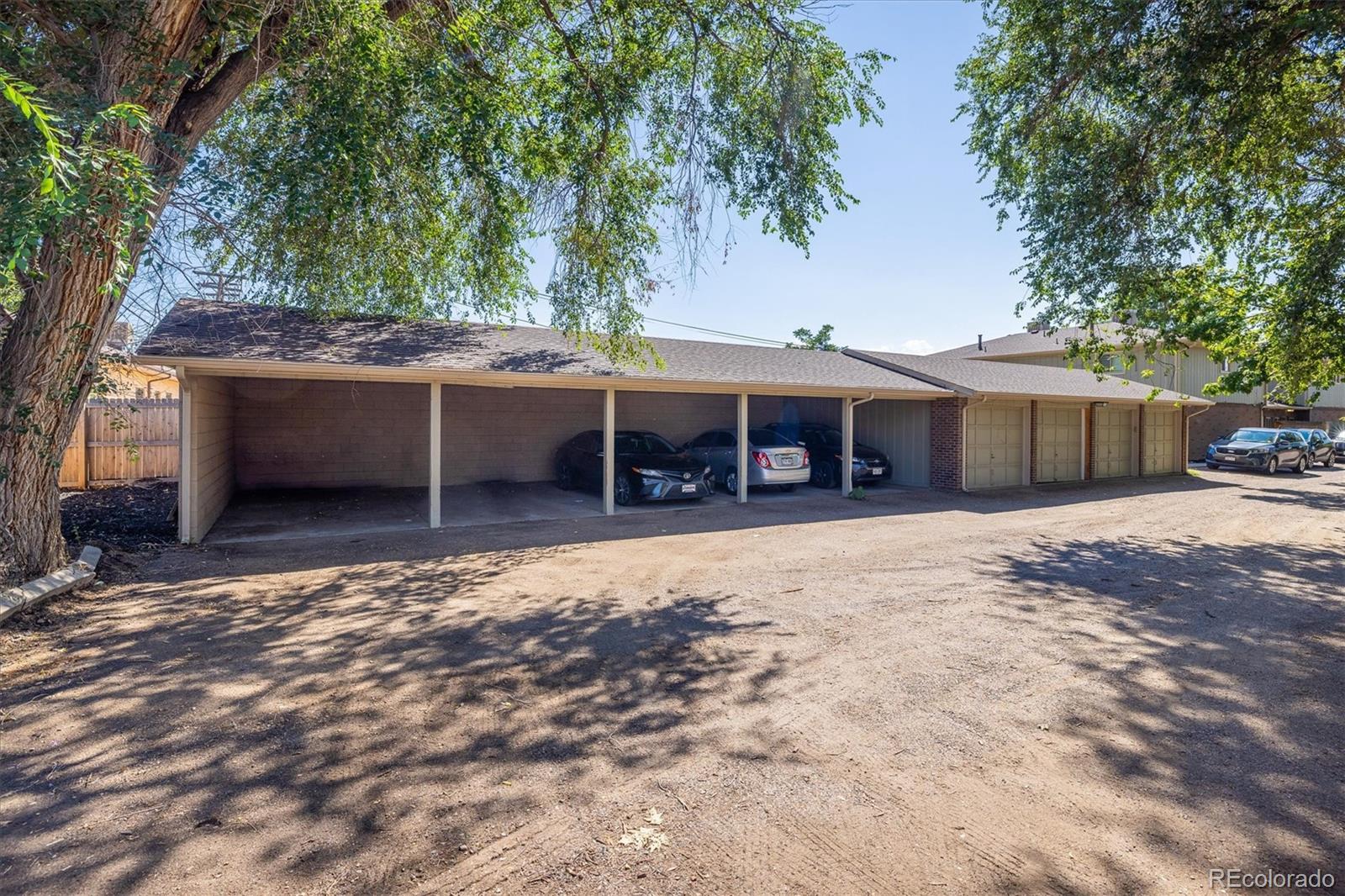 3830 Otis Street, Unit 14 Wheat Ridge, CO 80033 - Photo 22 of 26 a front view of a house with a garden