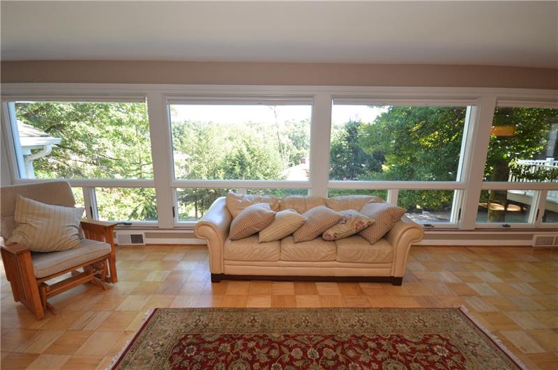 807 Valleyview Road Pittsburgh, PA 15243 - Photo 10 of 25 Familyroom with new carpeting, wall of windows, walk out to flagstone patio, wet bar and additional fireplace!
