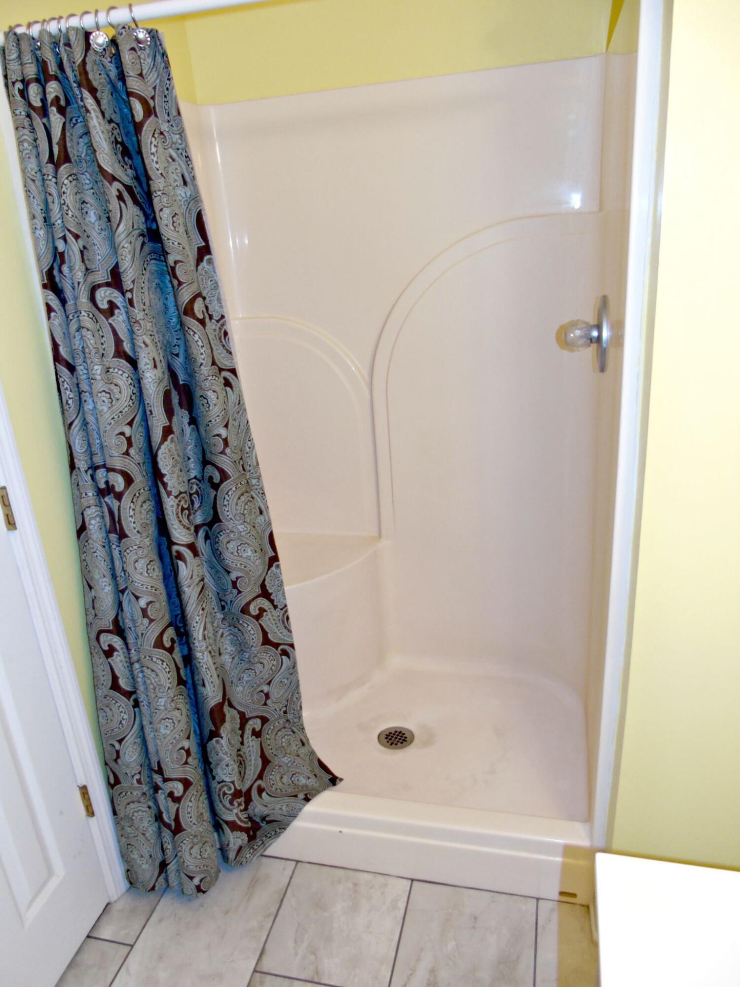 155 Spring Valley Lane Ringgold, GA 30736 - Photo 13 of 32 Walk-in shower with seat in main bedroom