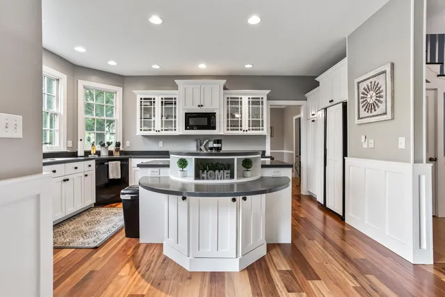 a kitchen with stainless steel appliances granite countertop a stove a refrigerator and a microwave