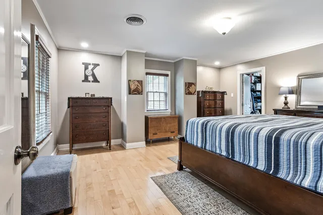 a bedroom with a large bed and balcony