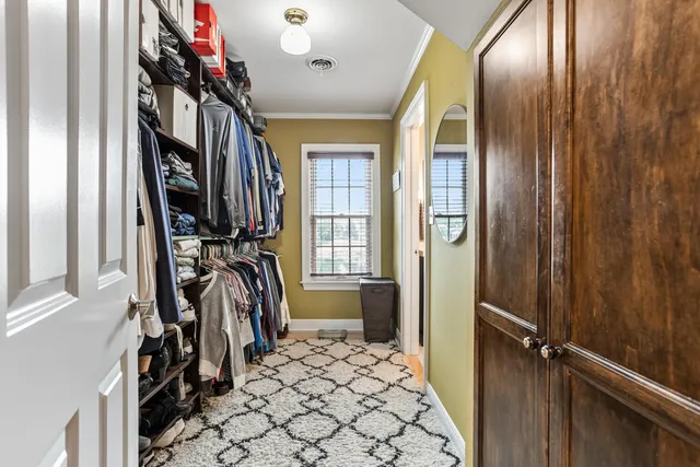 a view of a closet with wooden floor