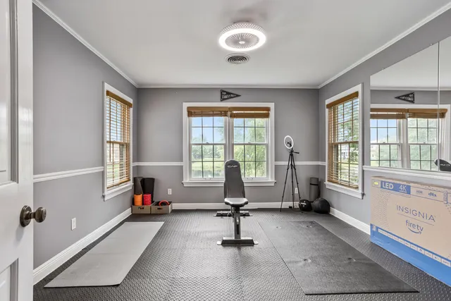 a view of a livingroom with workspace and windows
