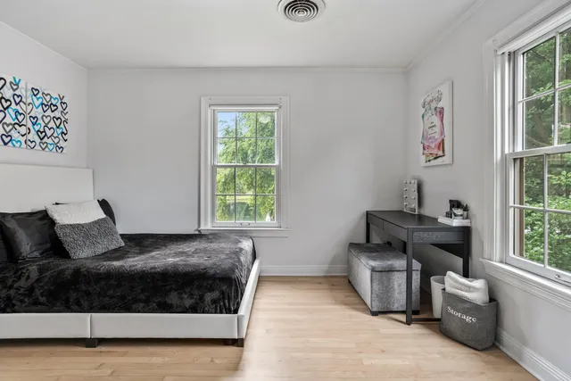 a bedroom with furniture and a window