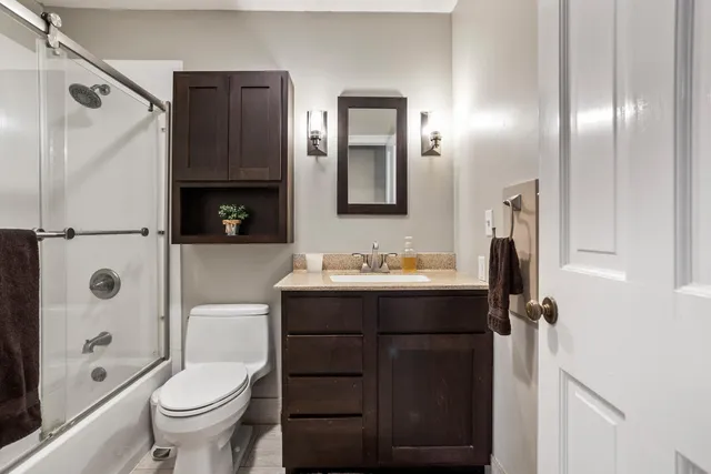 a bathroom with a sink toilet and shower