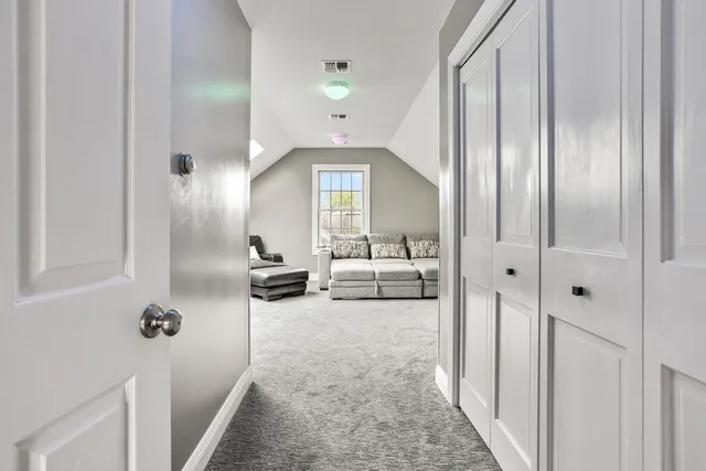 a living room with a flat screen tv and white walls