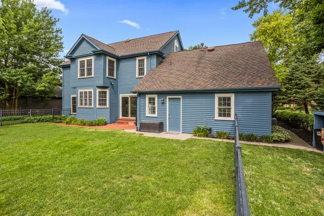 a front view of a house with a yard and lake view