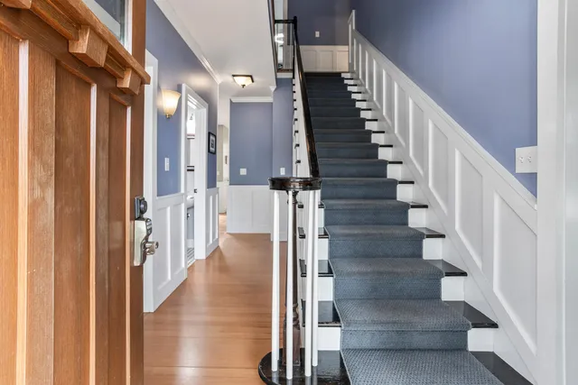 a view of entryway and gallery with wooden floor