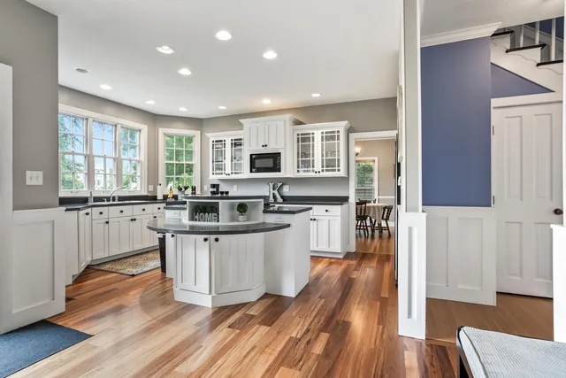 a large kitchen with lots of counter space and wooden floor