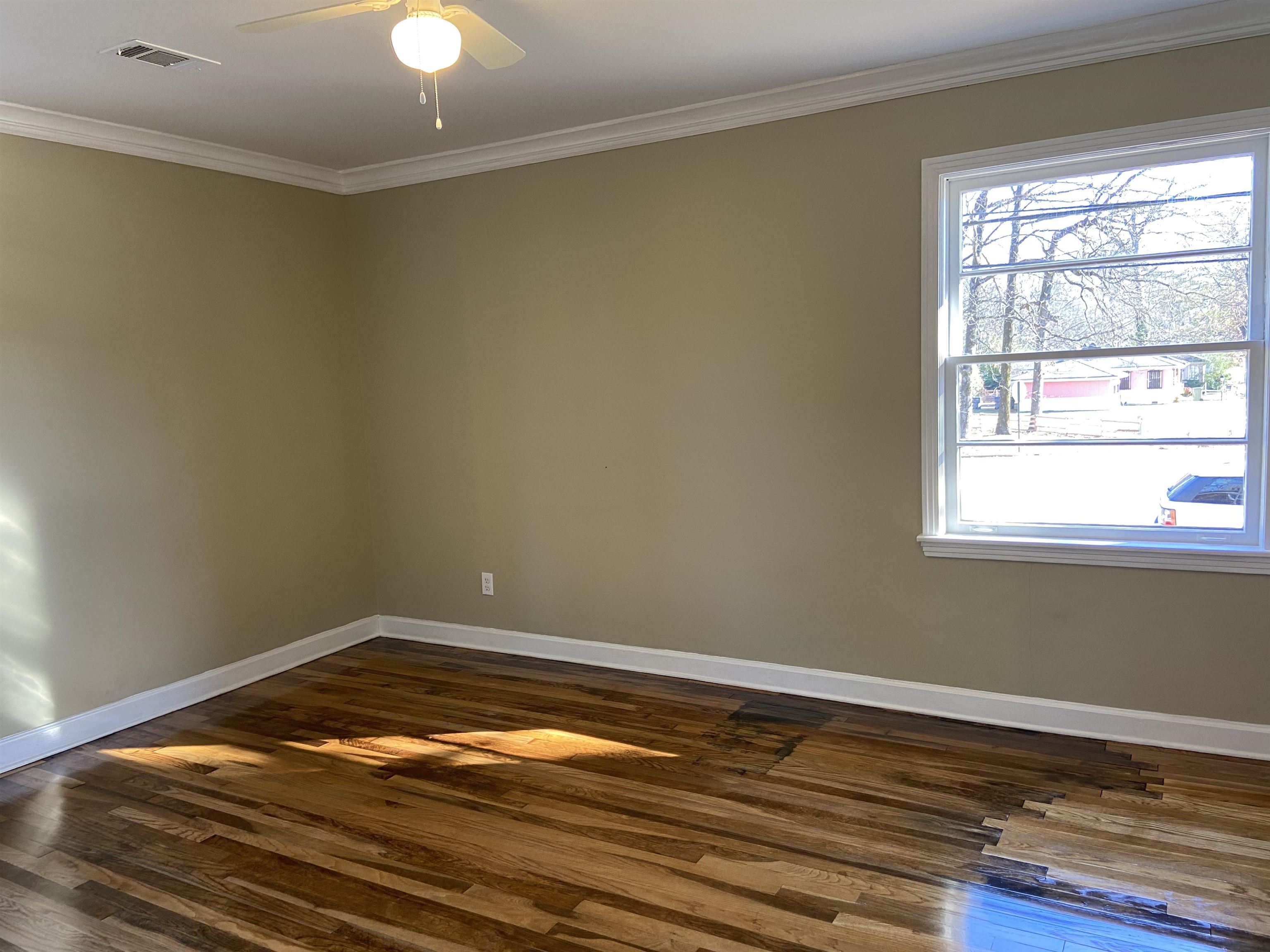1395 Prescott Road Memphis, TN 38111 - Photo 12 of 18 an empty room with wooden floor and windows