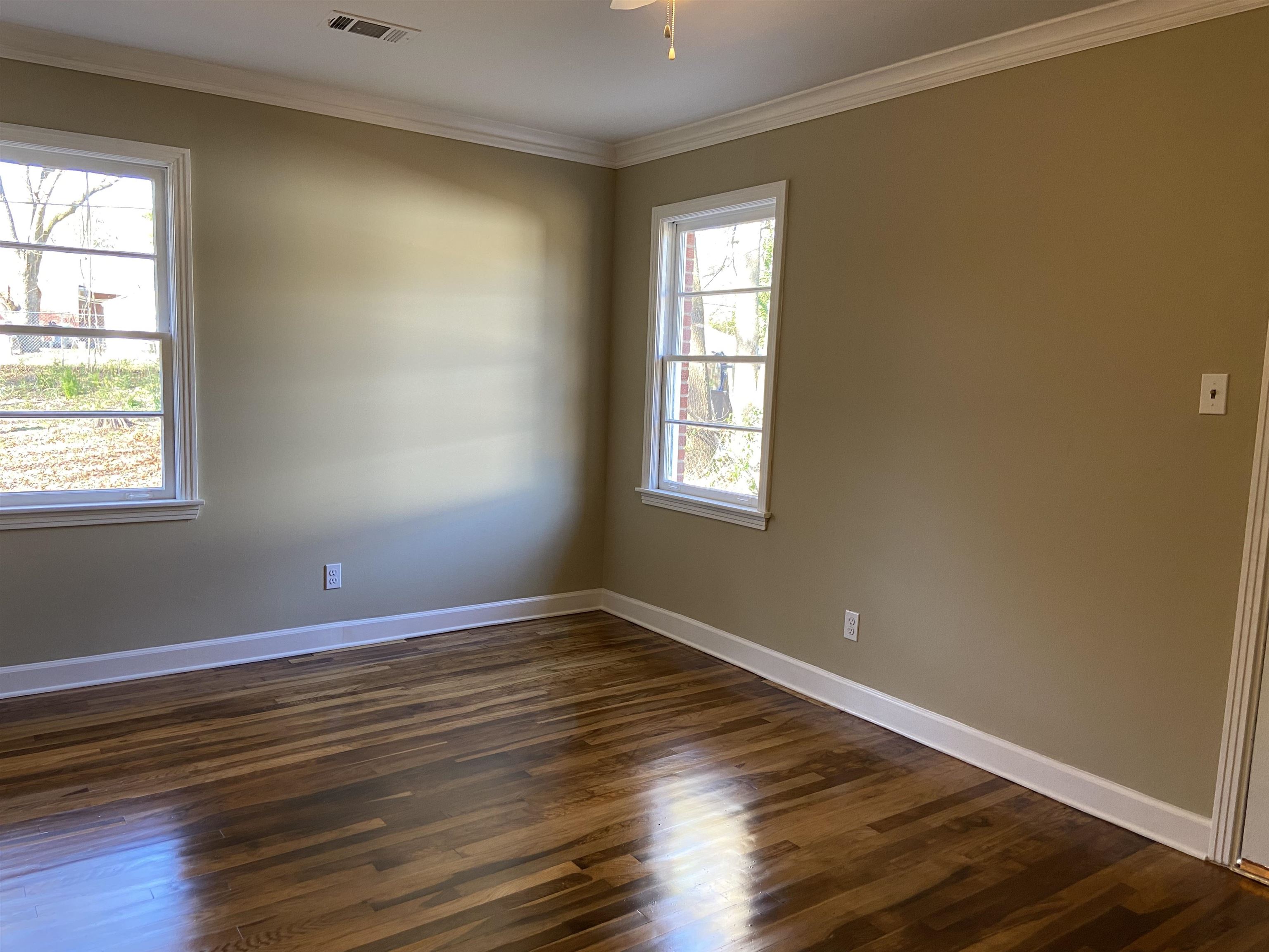 1395 Prescott Road Memphis, TN 38111 - Photo 14 of 18 a view of an empty room with wooden floor and a window