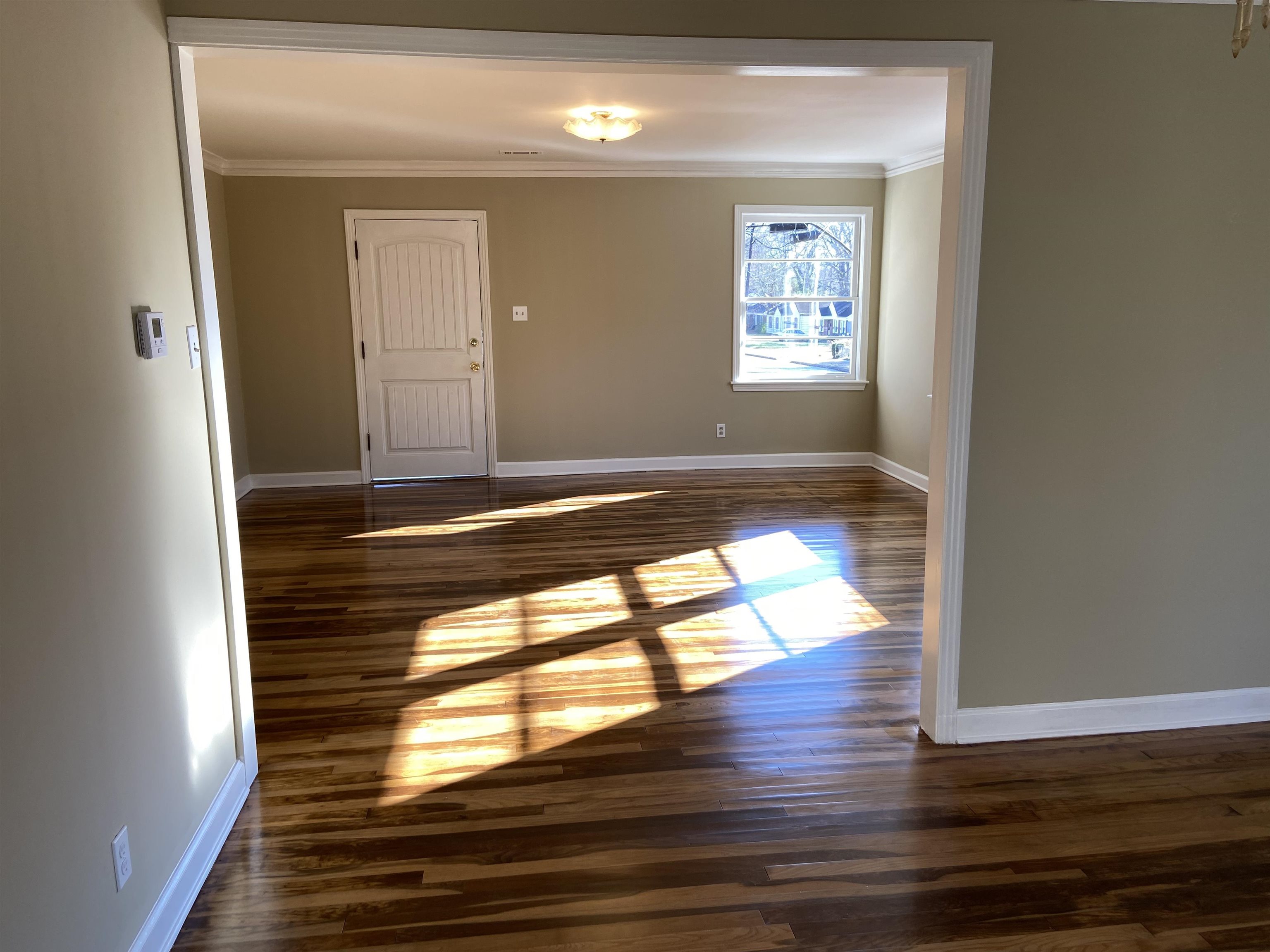 1395 Prescott Road Memphis, TN 38111 - Photo 3 of 18 a view of empty room with wooden floor and window