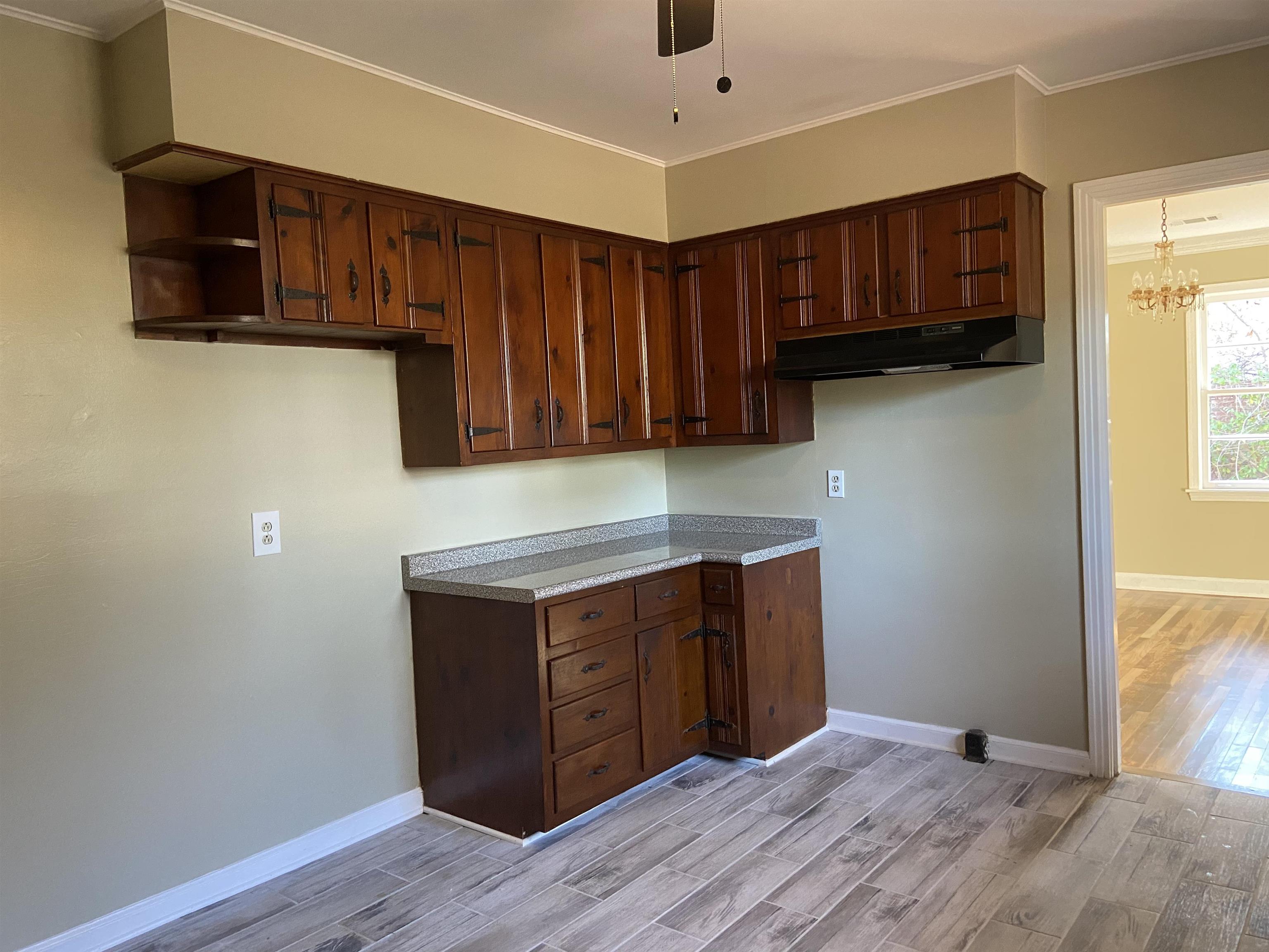 1395 Prescott Road Memphis, TN 38111 - Photo 7 of 18 a kitchen with stainless steel appliances granite countertop wooden cabinets a stove a sink and a window