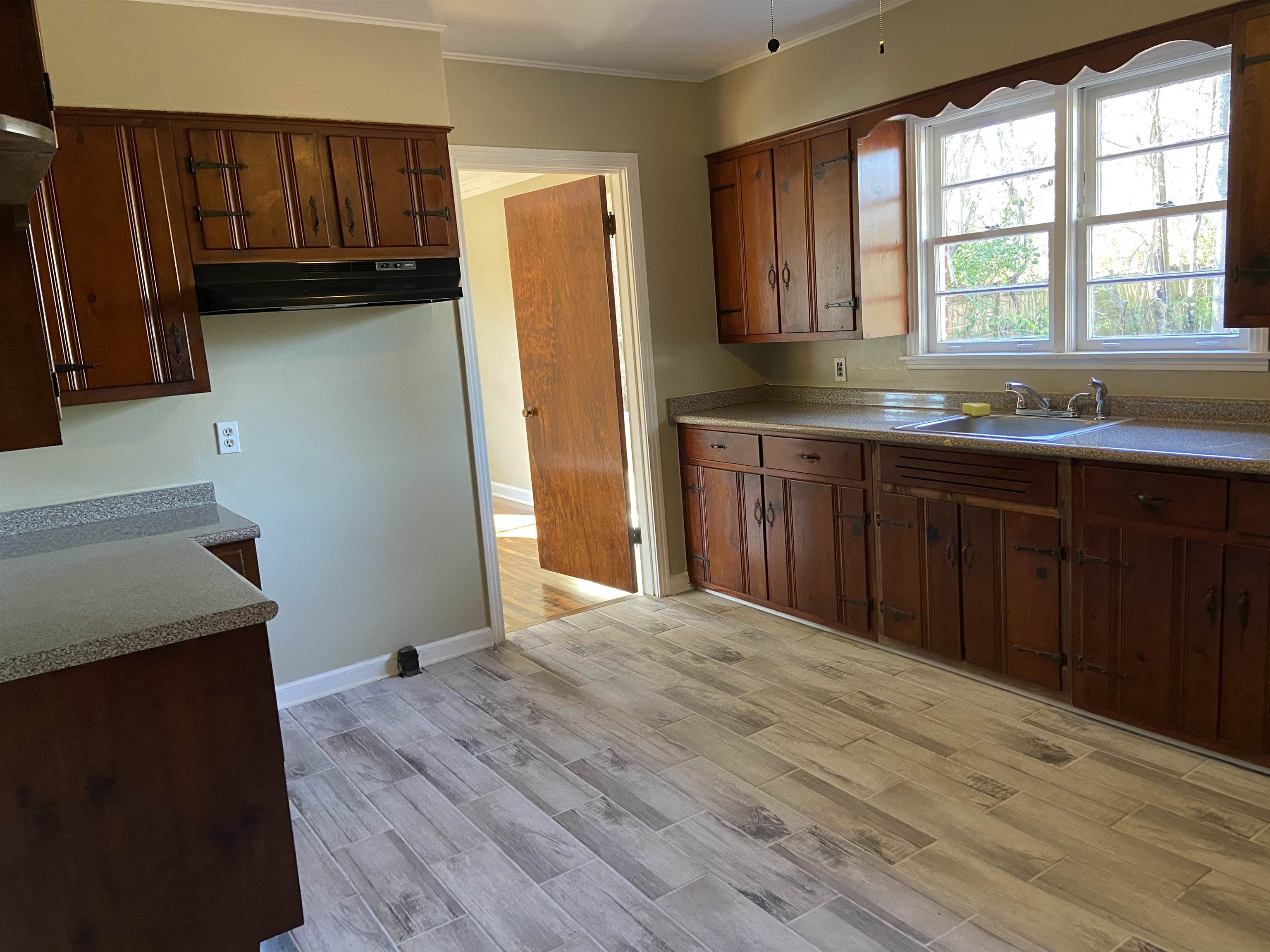 1395 Prescott Road Memphis, TN 38111 - Photo 8 of 18 a kitchen with a refrigerator and a sink