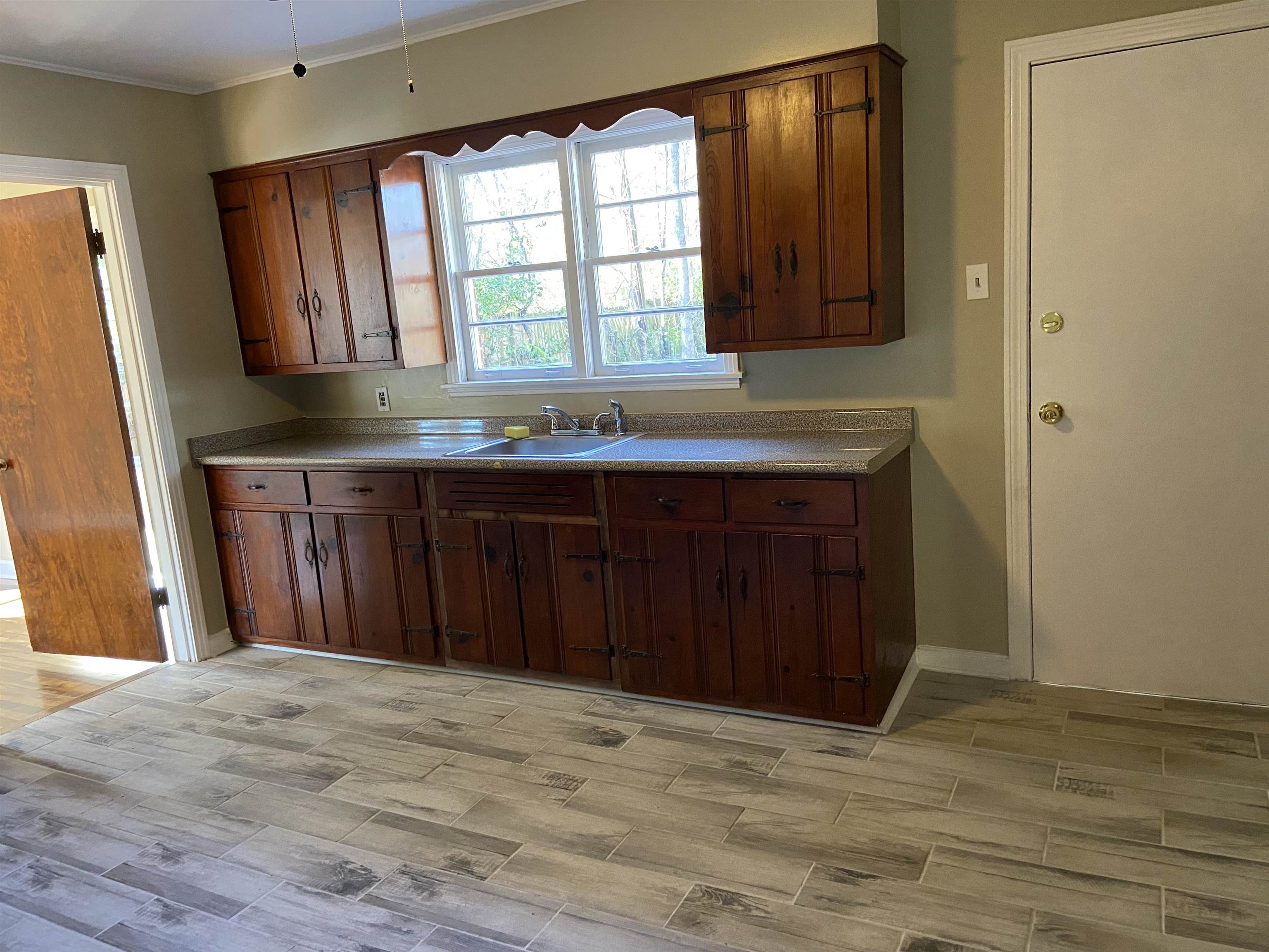 1395 Prescott Road Memphis, TN 38111 - Photo 9 of 18 a view of a kitchen with a sink and a window