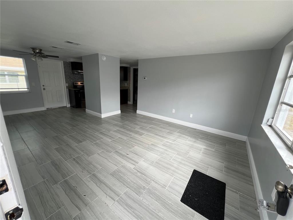5333 Pasadena Drive, Unit 5333 New Port Richey, FL 34652 - Photo 3 of 12 wooden floor in an empty room with a window