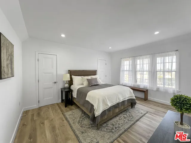 a bedroom with a large bed and a couch