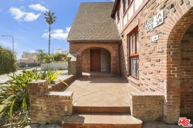 a front view of a house with outdoor seating