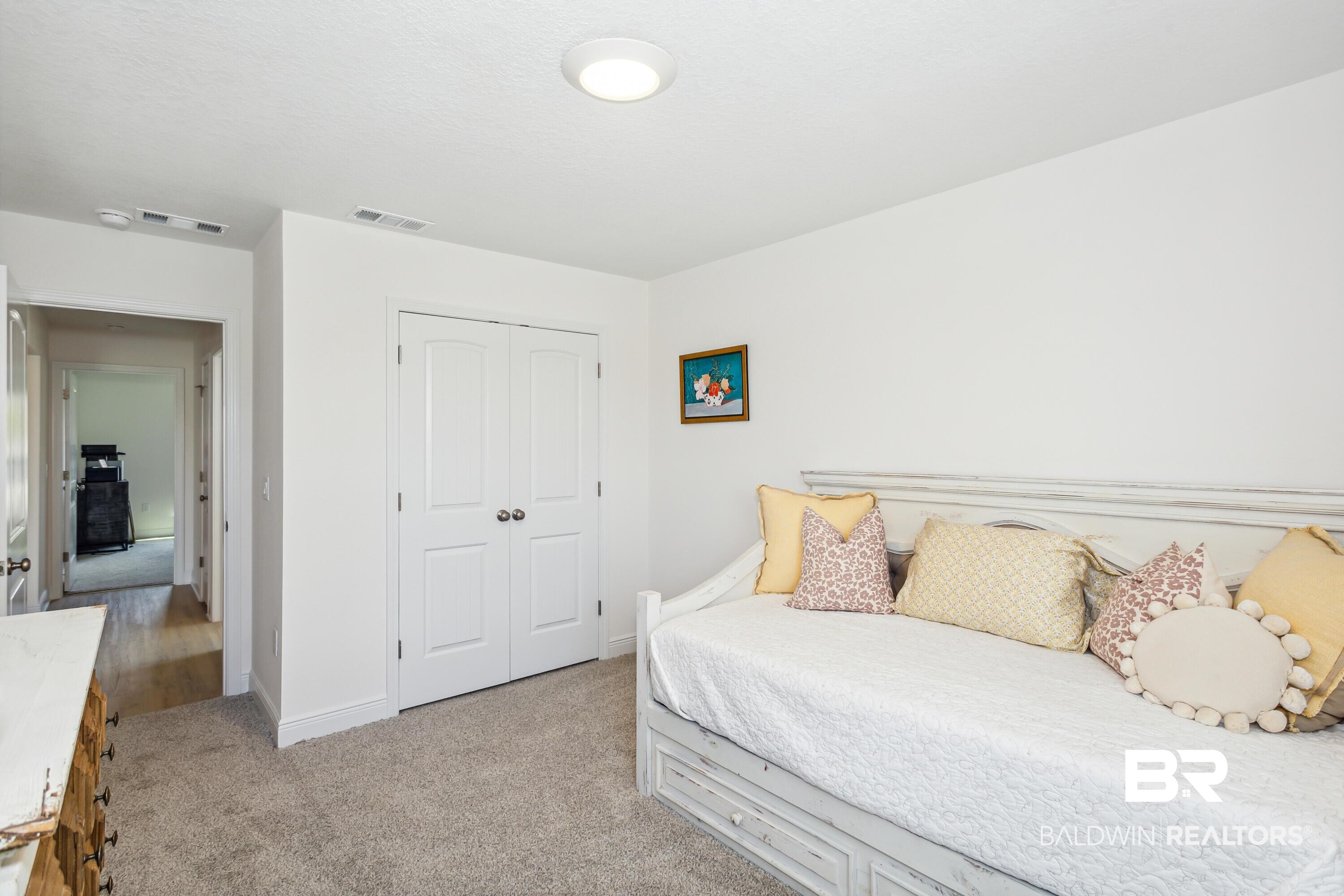 150 St Stephens Court Atmore, AL 36502 - Photo 16 of 21 Bedroom featuring light colored carpet and a closet