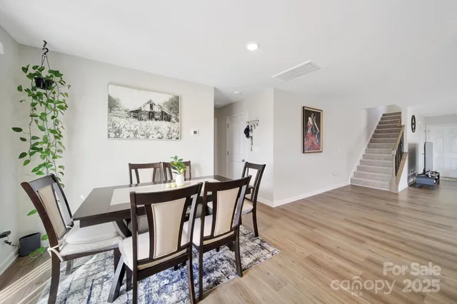 a view of a dining room with furniture wooden floor and front door