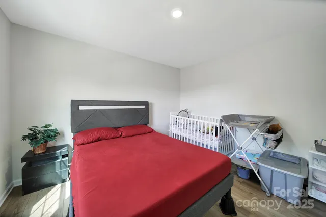 a bedroom with a bed and a potted plant