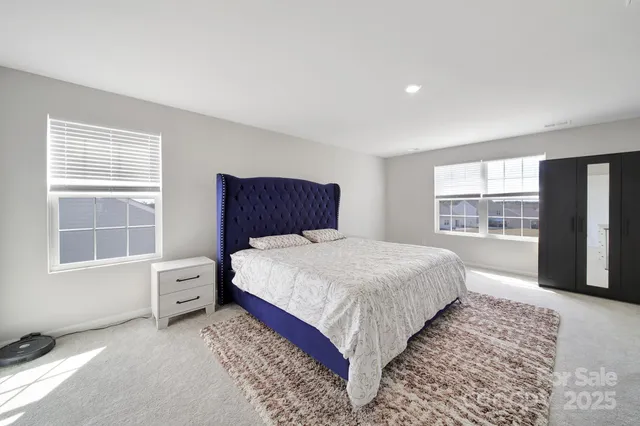 a bedroom with a large bed and a window