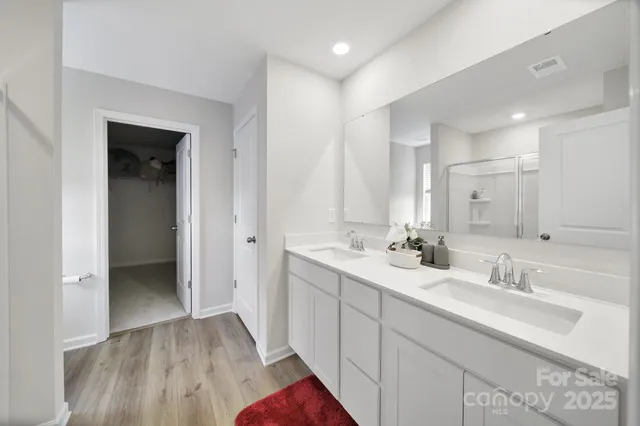 a bathroom with a double vanity sink and mirror