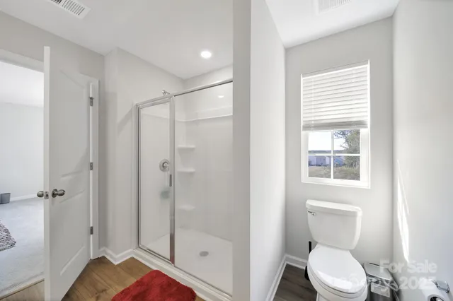 a white toilet sitting next to a bathroom sink