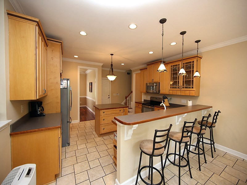 1313 Rhea Drive Garner, NC 27529 - Photo 6 of 25 The large kitchen has stainless steel appliances, pantry and island, along with the bar seperating the breakfast room. Kitchen