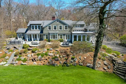 a front view of a house with a garden