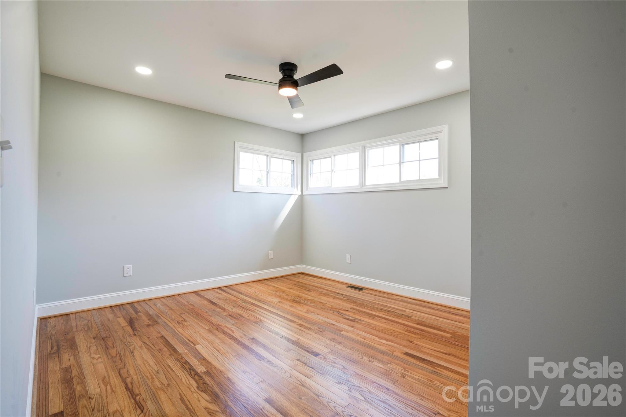 2822 Bettis Road Grover, NC 28073 - Photo 17 of 32 an empty room with wooden floor fan and windows